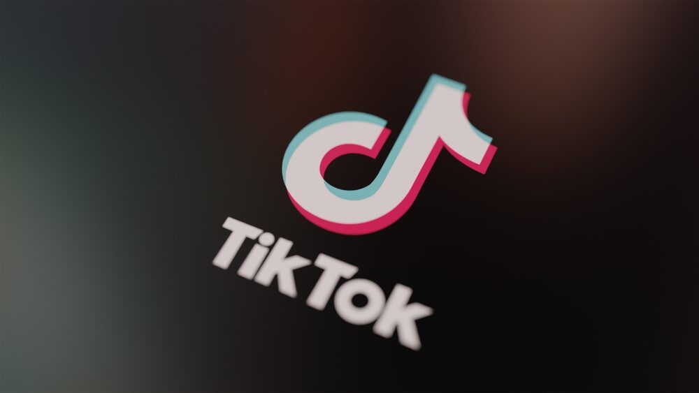 Logo di TikTok con sfondo di contenuti digitali